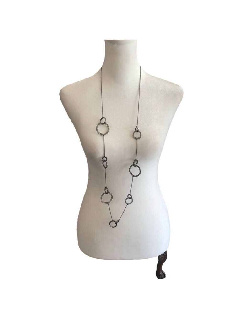 CHICO’S necklace with various shapes and sizes of rings, some with clear stones